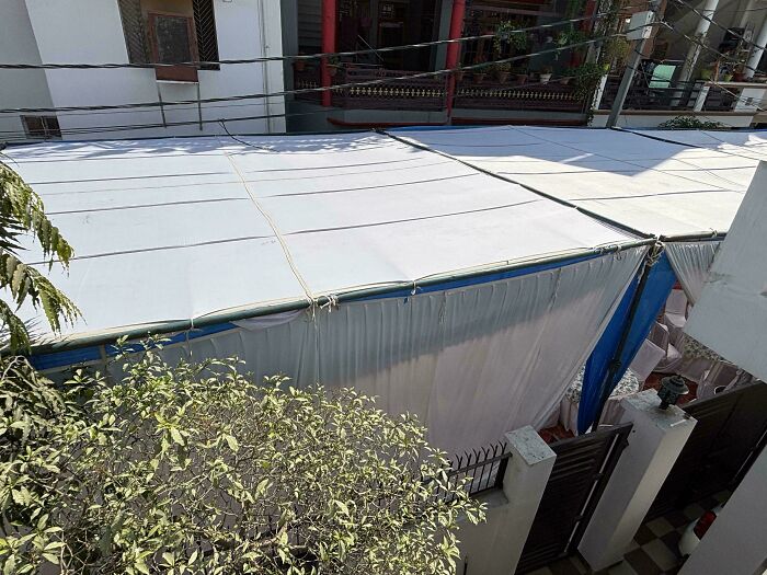 Large covered space blocking a residential street, showcasing entitled behavior.