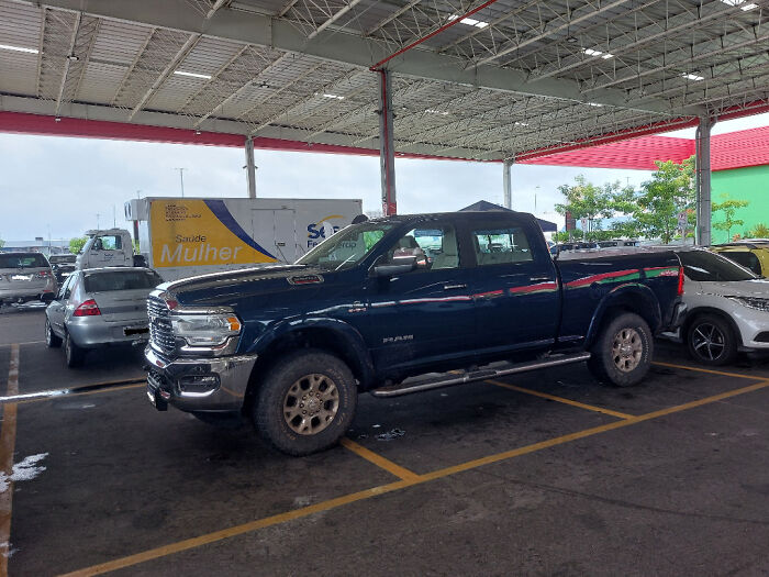 Entitled person parks large truck across multiple spots in a busy parking lot.