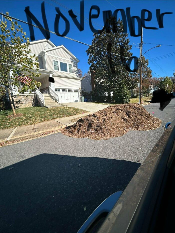 Pile of dirt blocking street in front of house, labeled "November," illustrating entitled behavior.