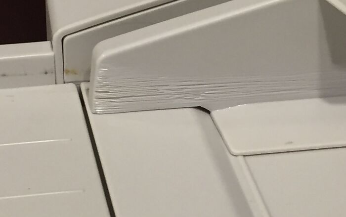 Close-up of a worn-out printer corner edge, illustrating wear over time vs. things durability.