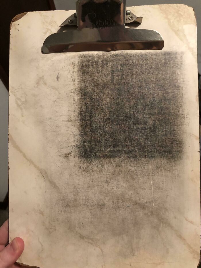 A worn clipboard with a metal clip showing signs of age and use, representing time vs. things.