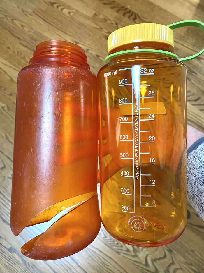 Old, c*****d bottle next to a new, intact water bottle, illustrating time's effect on things.