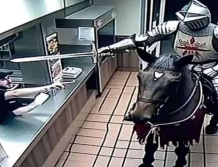 Knight on horseback in fast-food drive-thru, funny random moment.