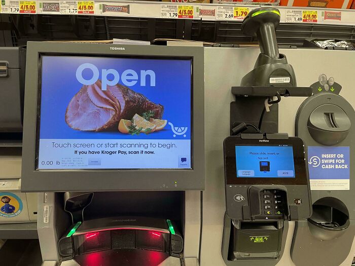 Self-checkout machine with display picture of ham, showcasing customer cluelessness at grocery store.