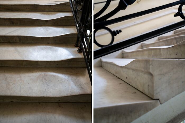 Worn marble stairs showing signs of things used over time, with smooth indents from frequent use.