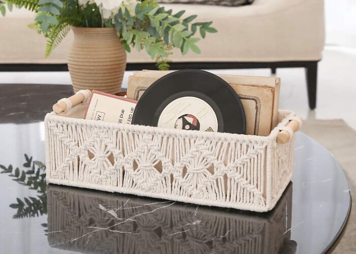Macramé basket with records on a table, a quirky gem adding both fun and functionality to home decor.