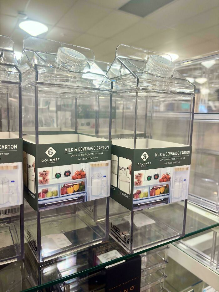 Clear plastic milk and beverage cartons displayed on a store shelf illustrating consumerism packaging trends.