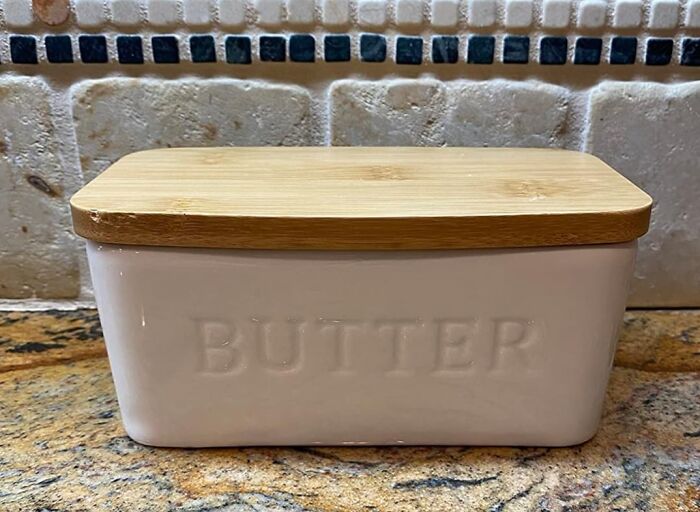 Ceramic butter dish with wooden lid on kitchen counter showing useful decor items that earn their keep.