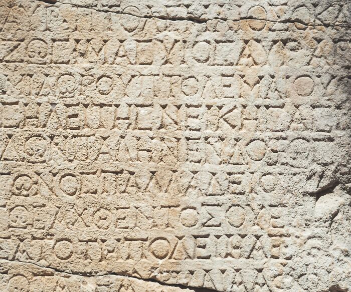 Ancient stone with Greek inscriptions, highlighting cool Wikipedia articles for reading and exploration.
