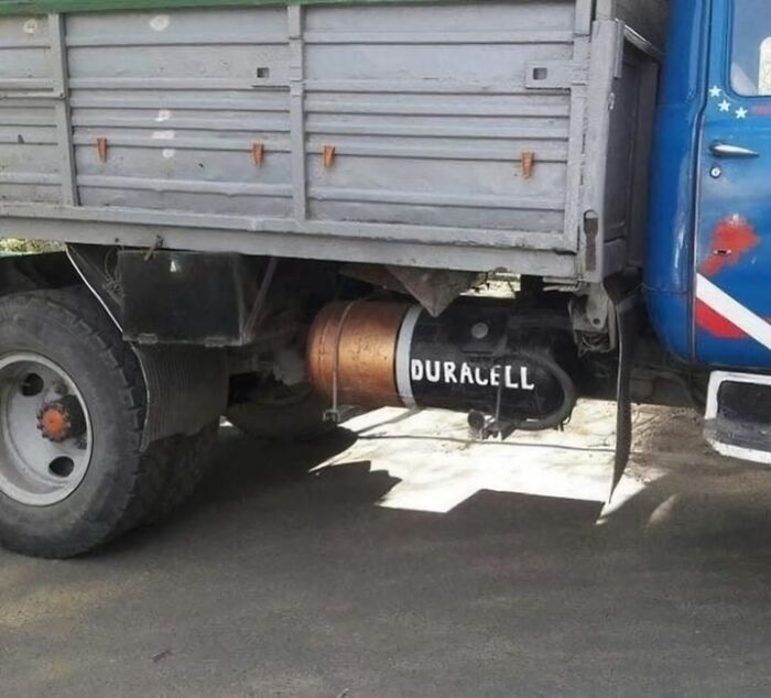 Truck with a large Duracell battery painted on its tank, creating a funny and random visual effect.