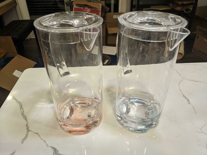 Two pitchers on a counter with upside-down lids, showcasing design fails.