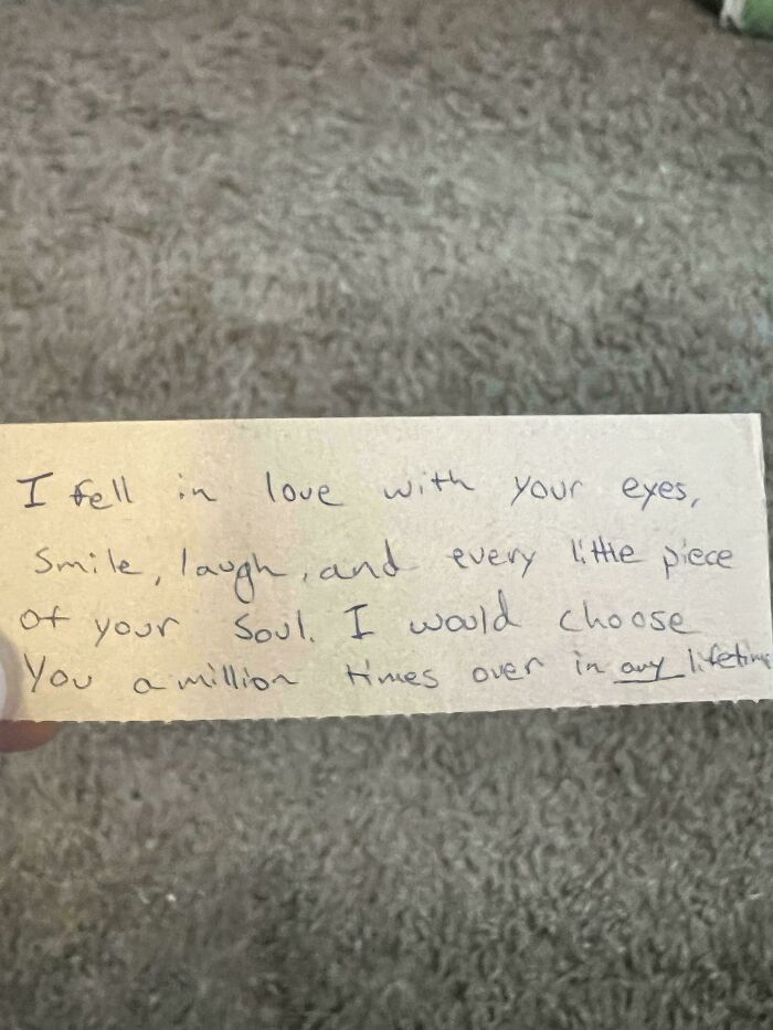 Handwritten love note bookmark on carpet background.