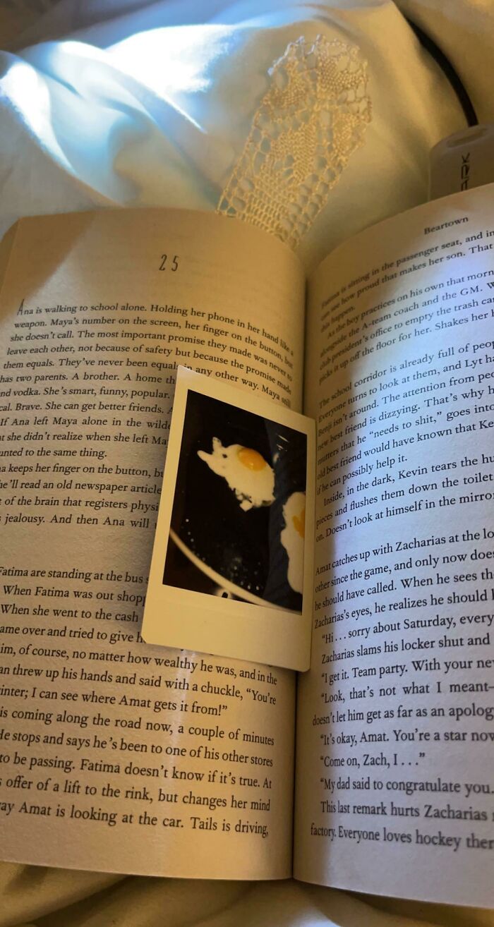 Polaroid photo used as a bookmark in an open book, showcasing a creative idea for book lovers.