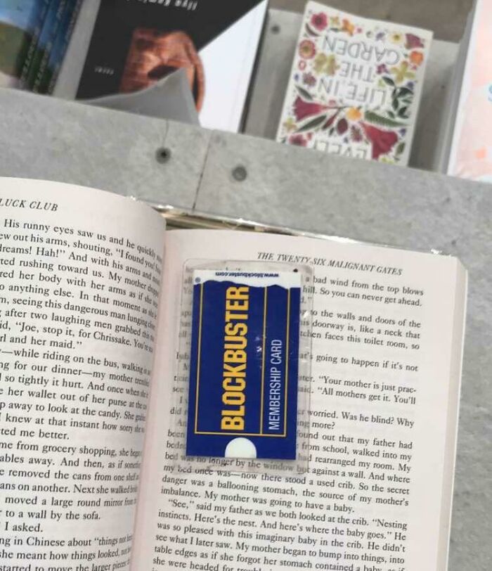 Book lovers use a vintage Blockbuster card as a unique bookmark between pages.
