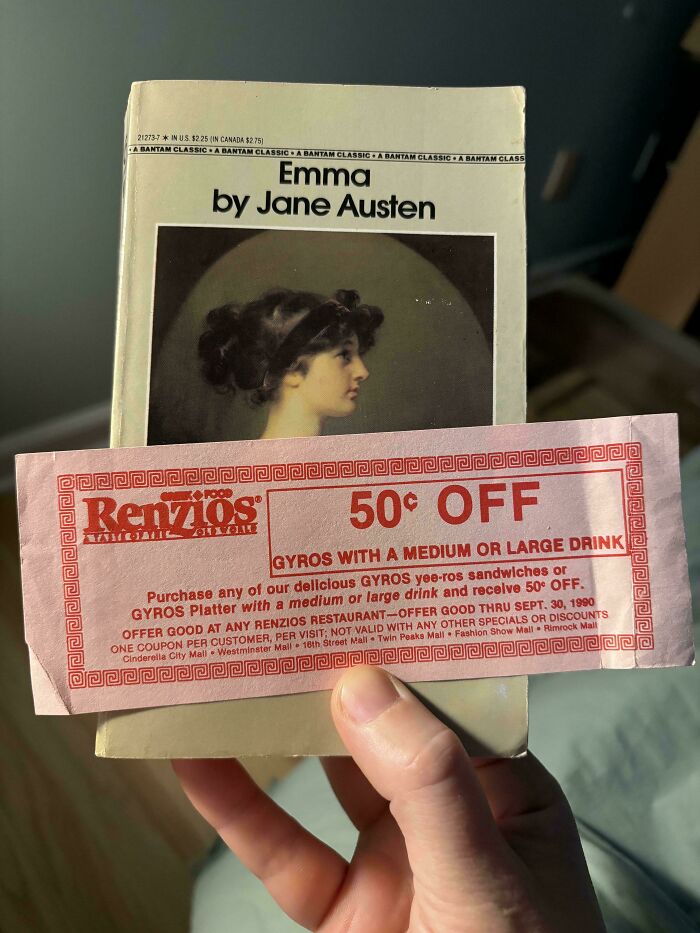 Book lover uses a vintage coupon as a bookmark in "Emma" by Jane Austen.
