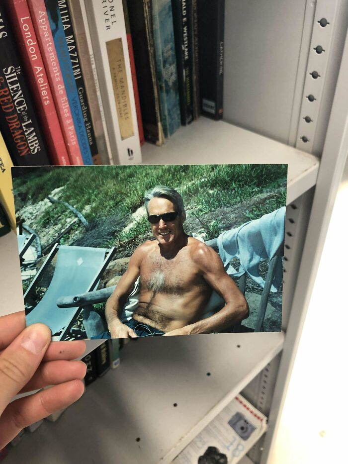 Photo used as a unique bookmark among books on a shelf, showcasing a creative book lover's find.