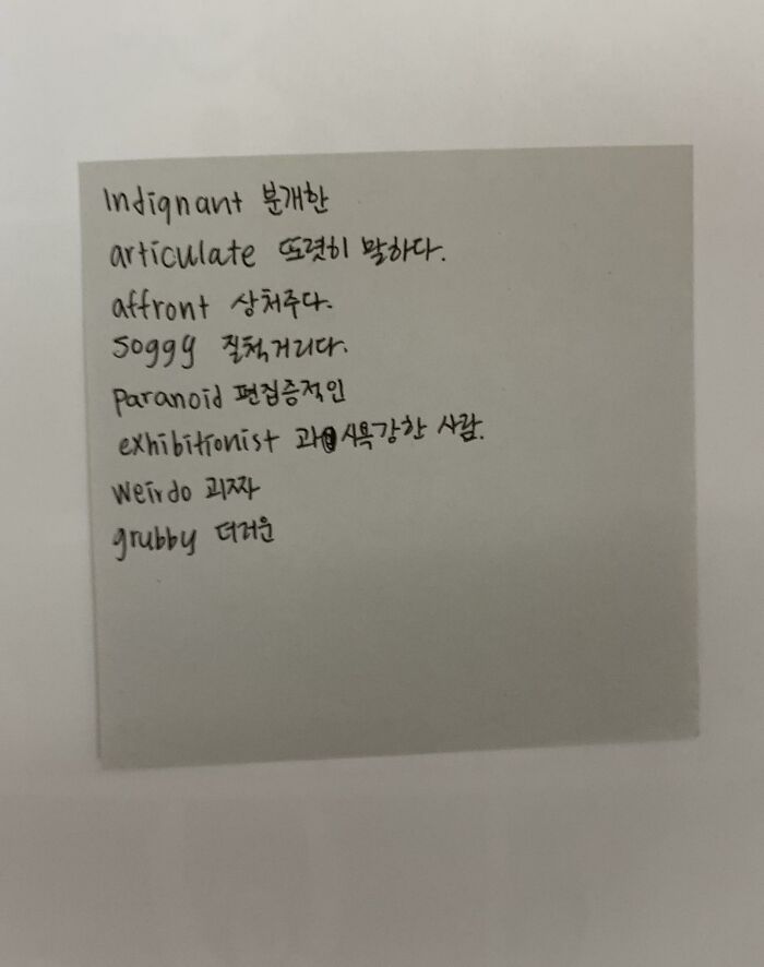 Handwritten notes in English and Korean on a paper square, found inside a book as a unique bookmark.