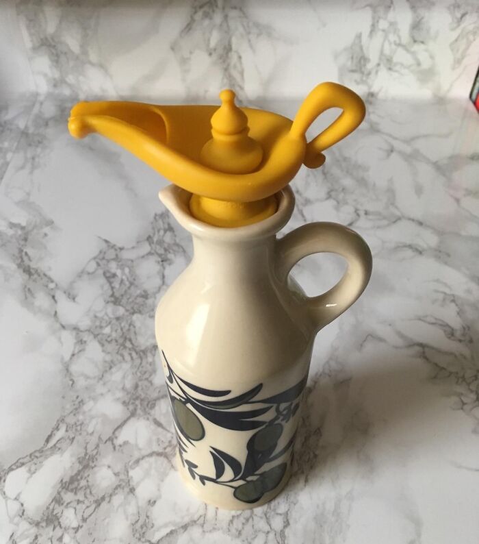 Ceramic olive oil bottle with a whimsical yellow spout by Peleg Design Shop.