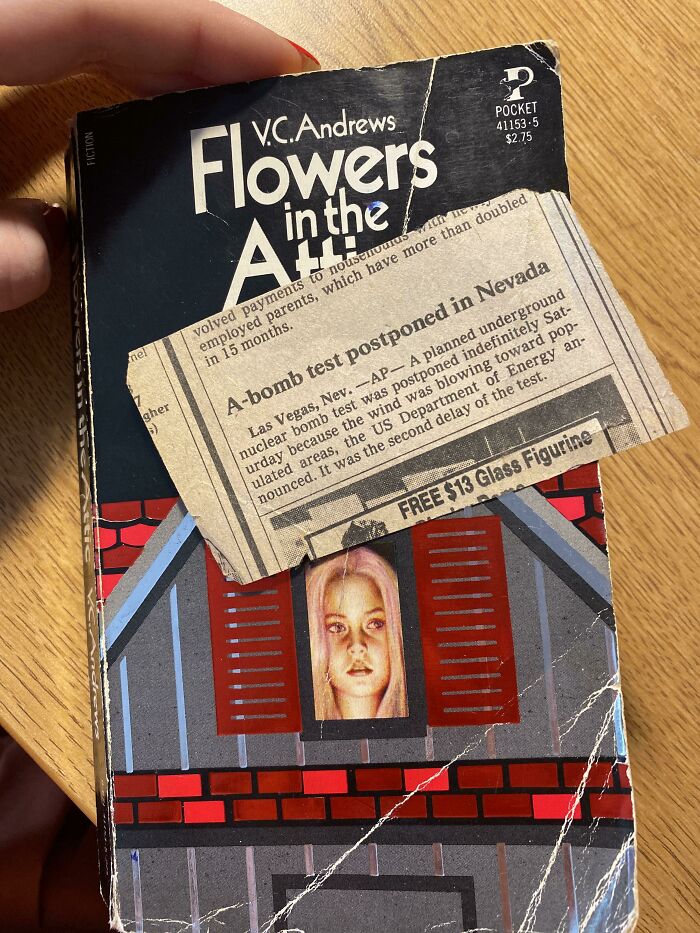 Vintage newspaper clipping bookmark in "Flowers in the Attic" book.