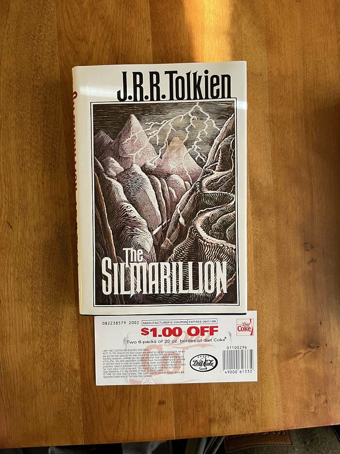 "The Silmarillion by J.R.R. Tolkien, with a Coca-Cola coupon bookmark, showcases a creative choice by a book lover."