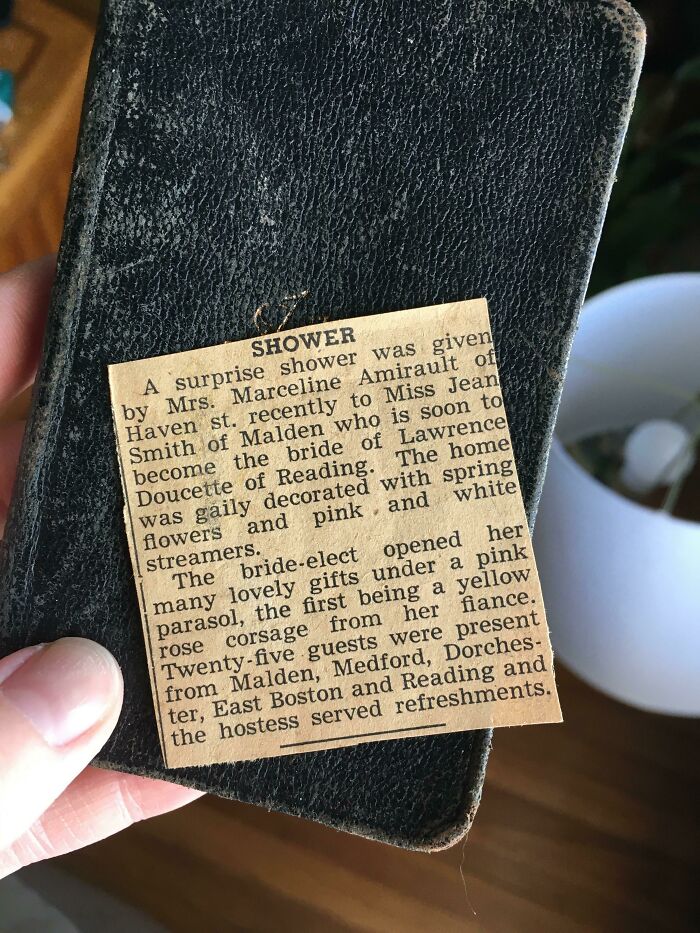 A vintage newspaper clipping used as a unique bookmark by a book lover.