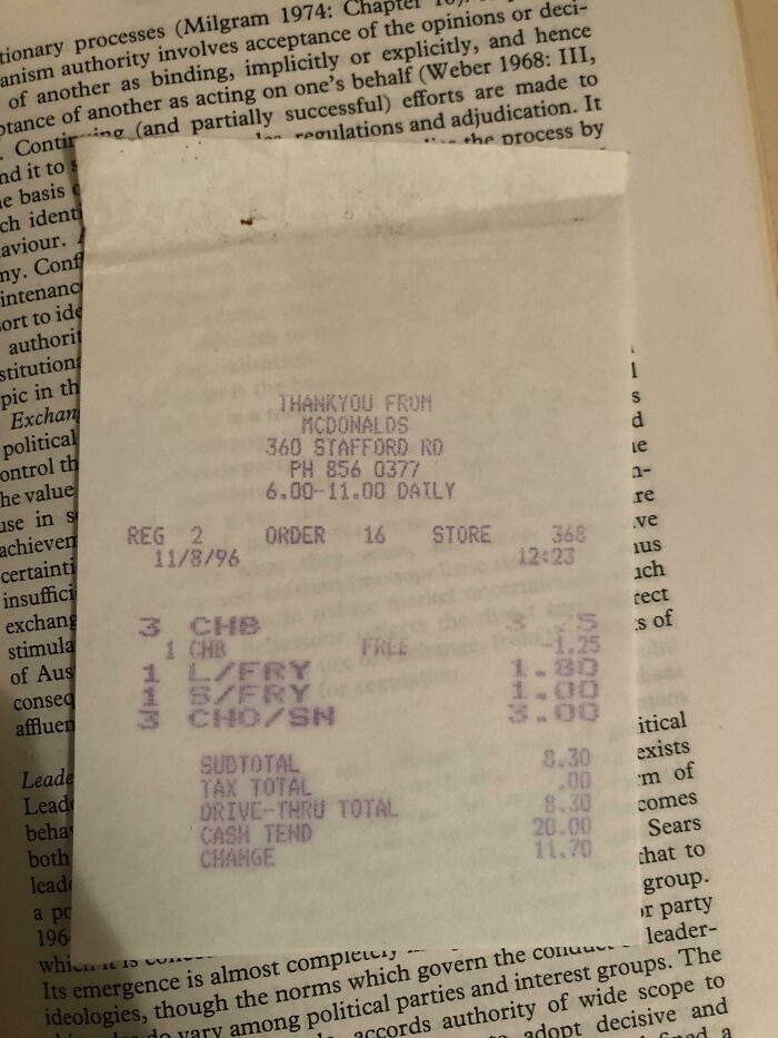 Receipt used as bookmark by a book lover over an open book page.