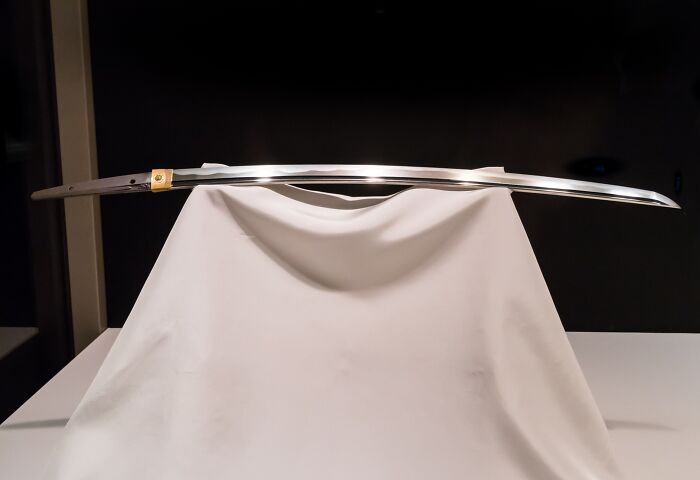 Lost treasure: a gleaming sword displayed on a white cloth, highlighting its historical significance and allure.
