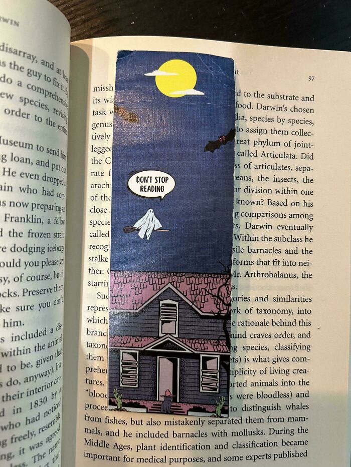 Ghost-themed bookmark with a house and moon, saying "Don't Stop Reading," for book lovers on an open book page.