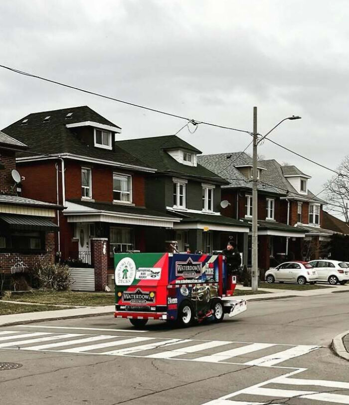 A small Zamboni driving on a residential street in Canada, capturing a quirky scene typical of Just Canada Things.