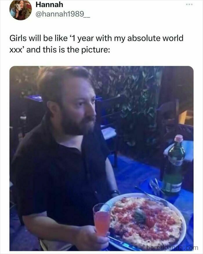 Man with serious expression sitting at a table with pizza and drink, reflecting a relatable middle class fancy meme.