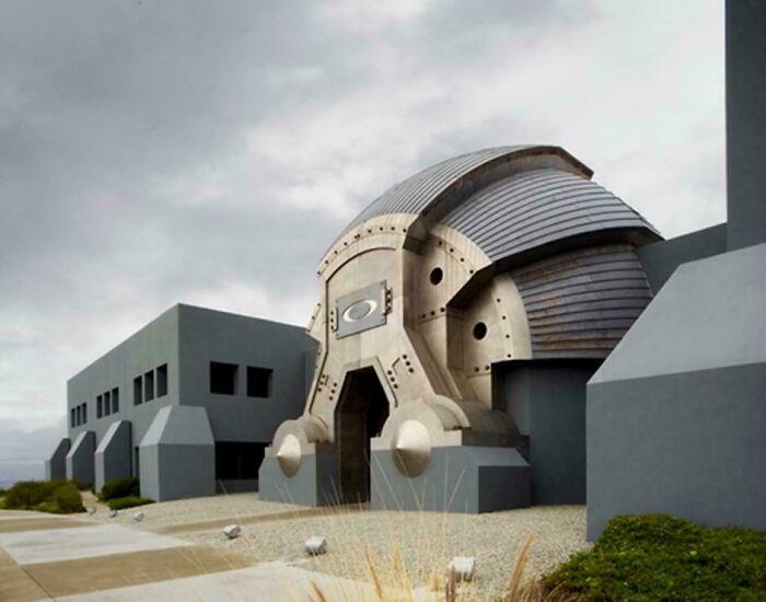 Futuristic building with an ominous design and dark gray structures, fitting the supervillain headquarters evil aura theme.