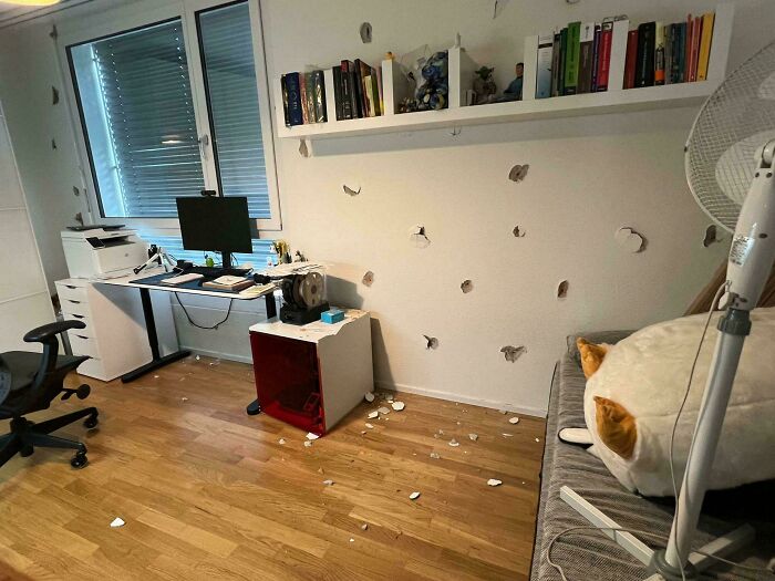 Room with damaged walls and scattered debris, showcasing an expensive accident aftermath.