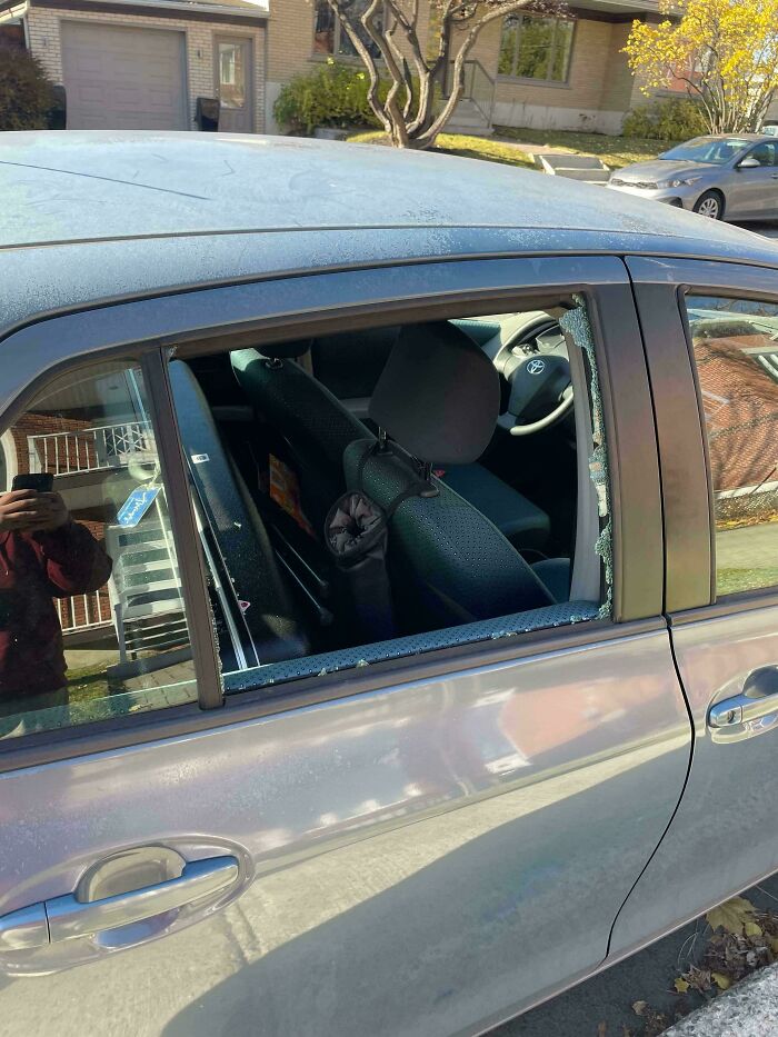 Car window shattered, showing evidence of an expensive accident.