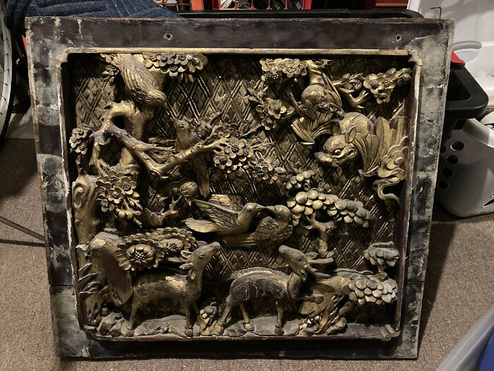 Ornate wooden carving depicting animals and foliage, showcasing intricate craftsmanship in a home-discovery-finds context.