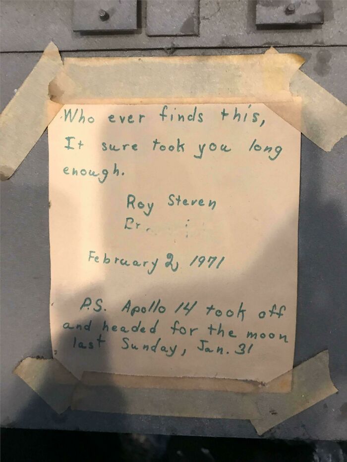 A vintage note taped to a surface reads a discovery about Apollo 14's moon mission.