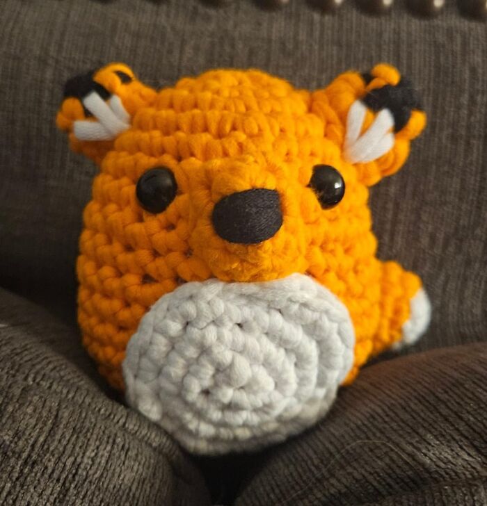 Crocheted fox plush toy on a couch, a most wished for item.