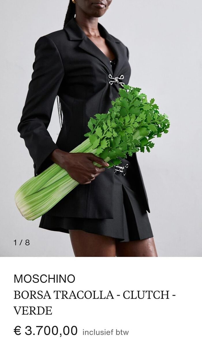 Fashion disaster: Model holding green clutch shaped like celery, wearing a black outfit.