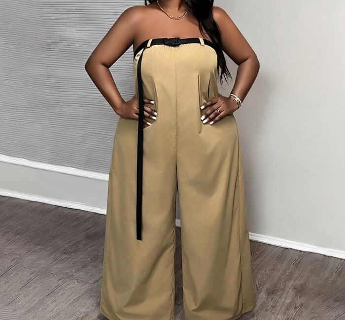 Person wearing a strapless beige jumpsuit with large pockets and black ribbon, exemplifying fashion disasters.