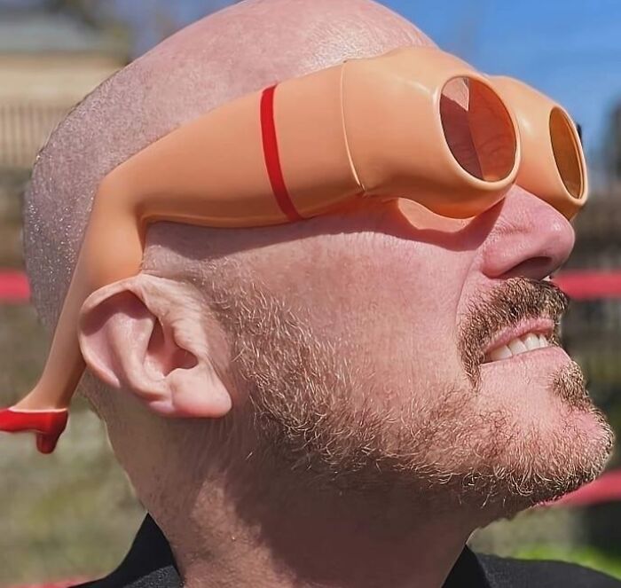 Man wearing novelty glasses shaped like legs in a humorous fashion disaster.