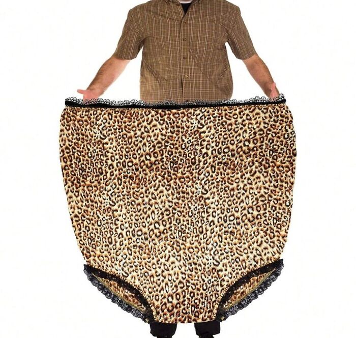 Man holding oversized leopard-print underwear, representing fashion disasters.
