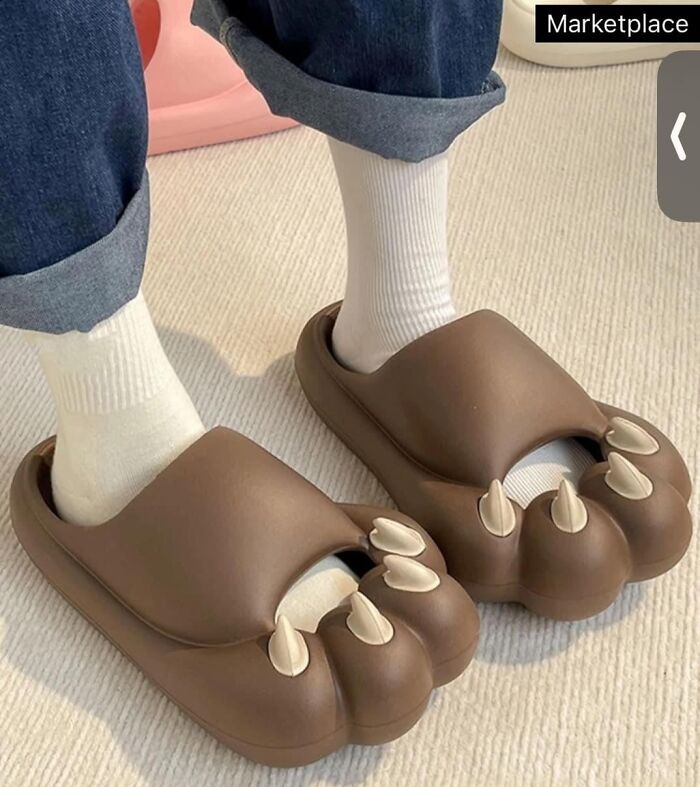 Brown novelty claw sandals worn with white socks in a fashion disaster.