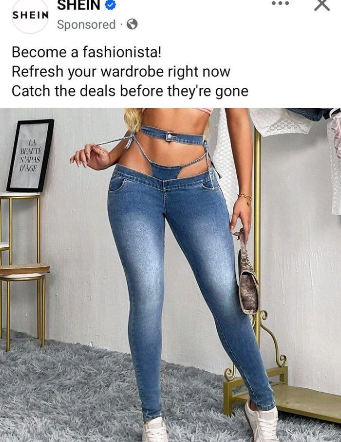 Woman in unconventional jeans style, standing in a room, showcasing a fashion disaster.