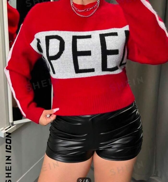 Red sweater with "PEE" text and black shorts, example of fashion disasters.