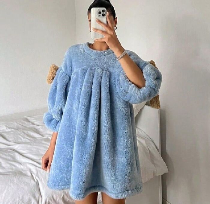 Person in a blue fluffy dress taking a mirror selfie, showcasing an unusual fashion disaster.