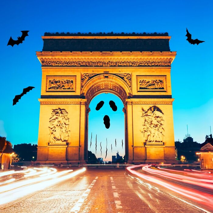 Arc de Triomphe with creative illustration of bats and face by Robin Yayla, blending art with scenery.