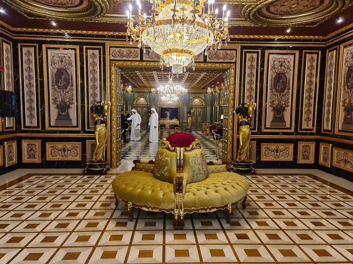 Luxurious interior with chandeliers and gold decor, showcasing opulent style only in Dubai.