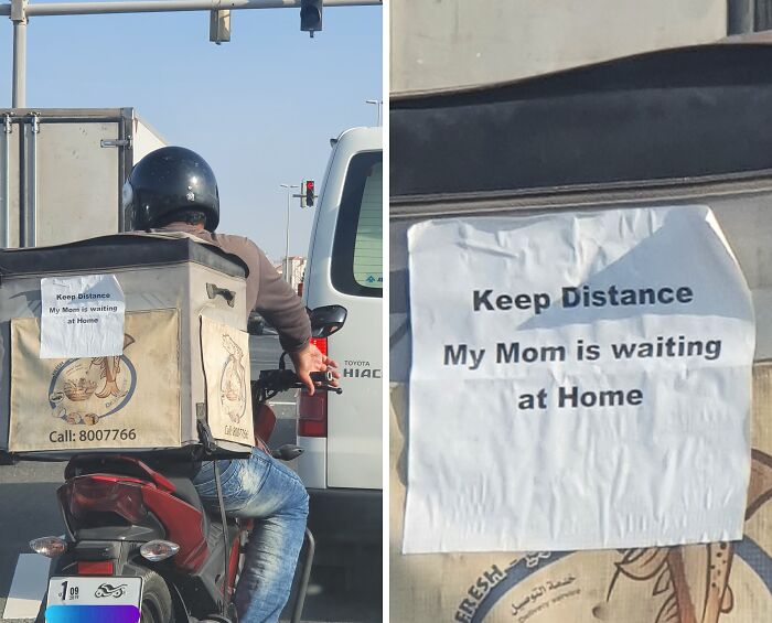 Delivery driver in Dubai with a sign saying "Keep Distance, My Mom is waiting at Home" on the backpack.