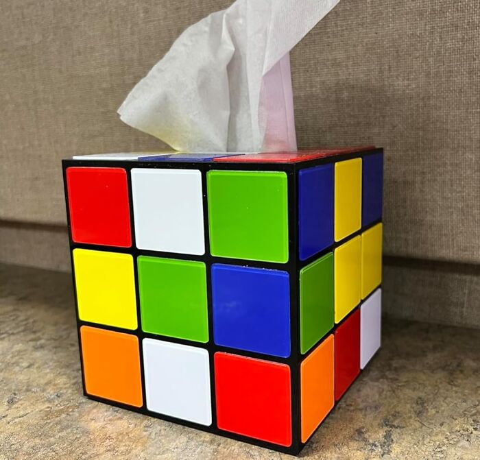 Rubik's Cube design tissue box, reminiscent of 90s kids' toys, with a tissue emerging from the top.