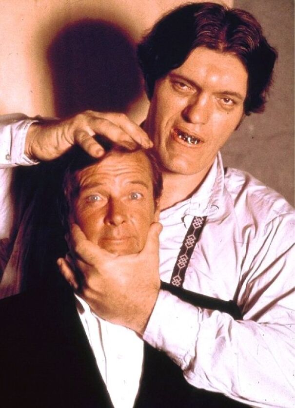 "Two men posing, one gently holding the other's head, showcasing an interesting historical perspective."