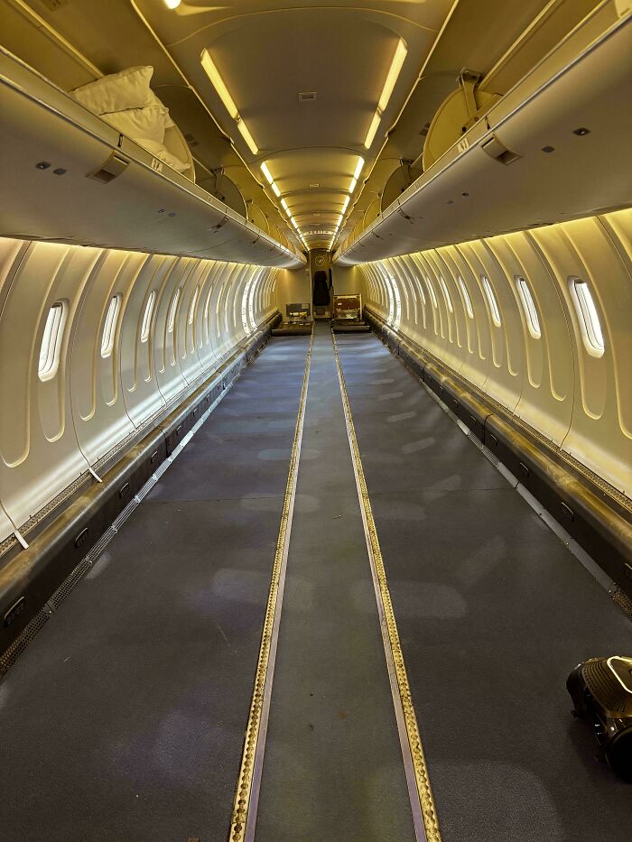 Empty airplane interior without seats, highlighting spacious cabin layout of iconic places.